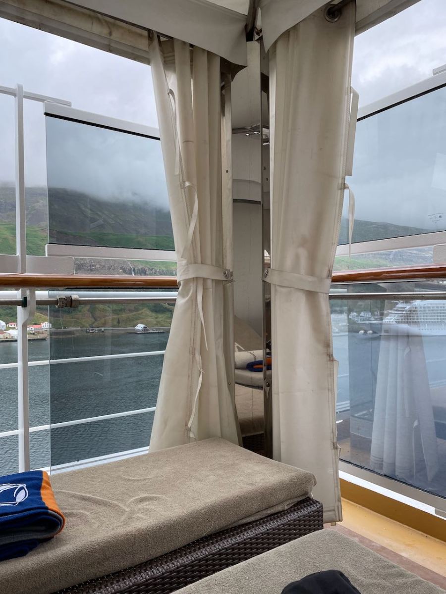 Curtains pulled back to show partially plexiglass covered view in two directions